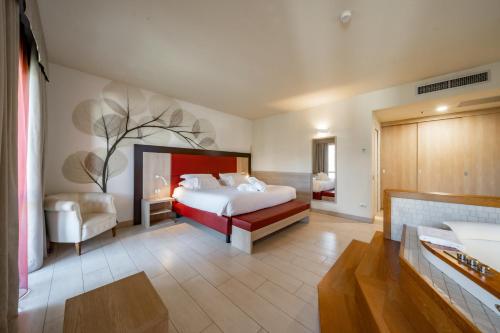 a bedroom with a bed and a chair in a room at Hotel Griso Collection in Malgrate