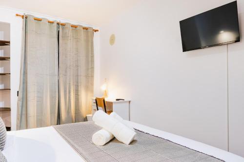 a bedroom with a bed with a flat screen tv at Vistoso Alto Palace in Lisbon