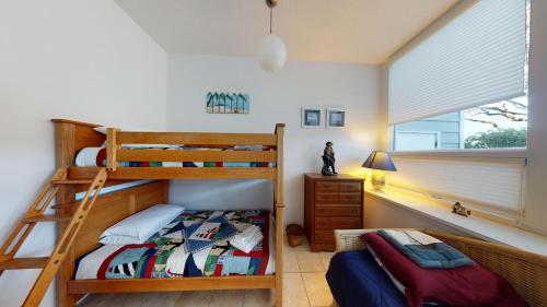 a bedroom with two bunk beds and a window at Ocean Retreat in Jekyll Island