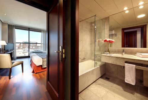 a bathroom with a tub and a sink at Crisol Vía Castellana in Madrid