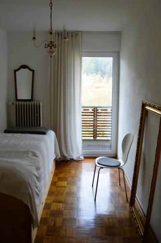 a bedroom with a bed and a mirror and a chair at Ferienwohnung Grüne Boje in Bullay
