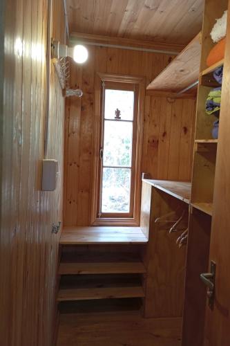 a small kitchen with a window in a tiny house at Palmera el Refugio in Olmué