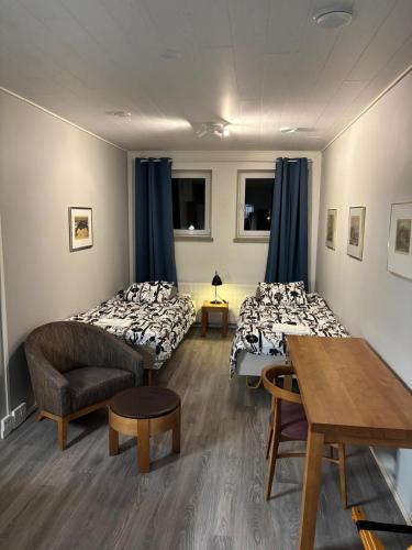 a room with two beds and a table and chairs at Inari Camping & Resort in Inari