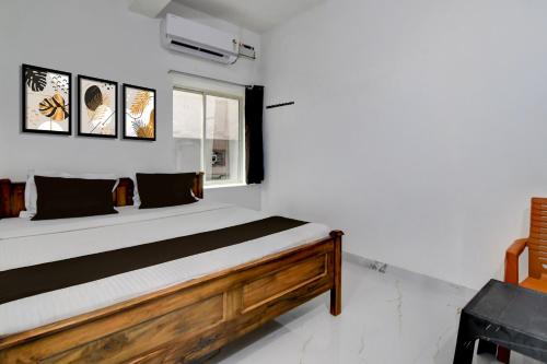 a bed in a room with a window at Hotel O Shree Guest House in Khandagiri