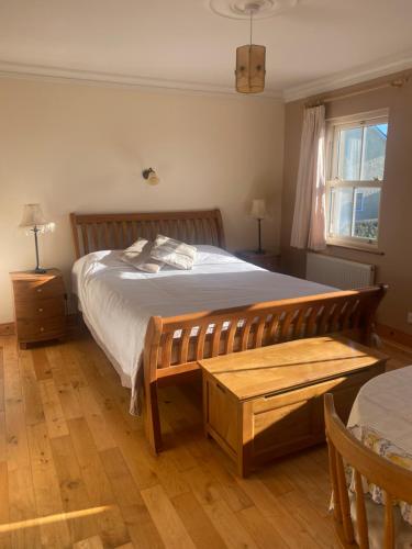 a bedroom with a large bed with a wooden frame at scenic estuary way home in Labasheeda