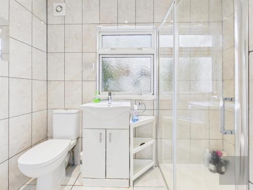 a bathroom with a toilet and a sink and a shower at 3 Bed House in Reading Area in Reading