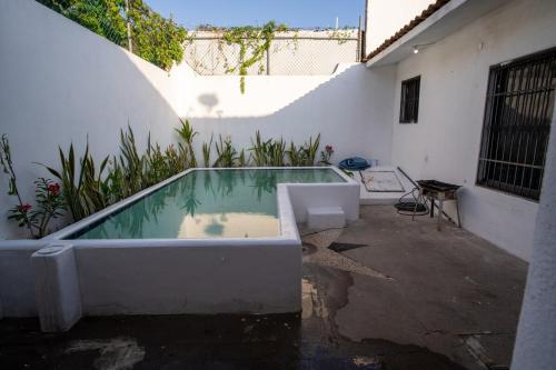 a bath tub sitting outside of a building at Casa Rubí comfortable and with a private pool in Zihuatanejo