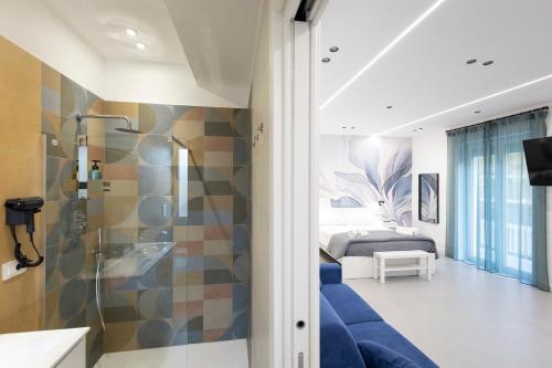 a bathroom with a shower and a bed in a room at Meraviglia B&B - Salerno Centro Close to the Station and Pier in Salerno