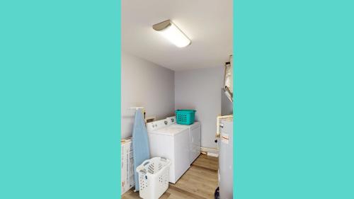 a laundry room with a washer and dryer at Turtle's Nest Duplex in Jekyll Island