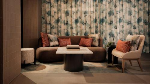 a living room with a couch and a table at Hotel Indigo Torquay, By IHG in Torquay