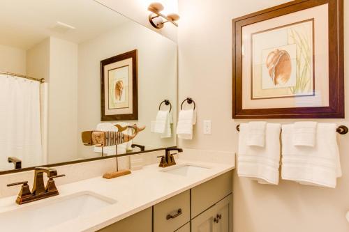 a bathroom with two sinks and a large mirror at 408B The Lynnhaven House in Virginia Beach