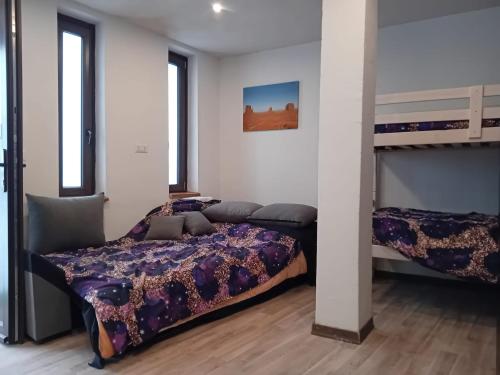 a bedroom with two beds and a bunk bed at Alloggio Centro Torgnon vicino impianti sci in Torgnon