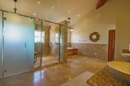 a bathroom with a shower and a glass shower stall at Luxury All-Inclusive Prince Private Island in San Pedro Island