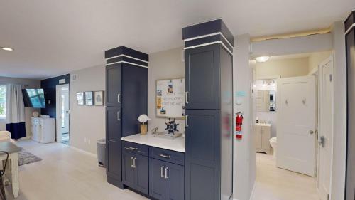 a bathroom with navy blue cabinets and a sink at Sea Haven Duplex A in Jekyll Island