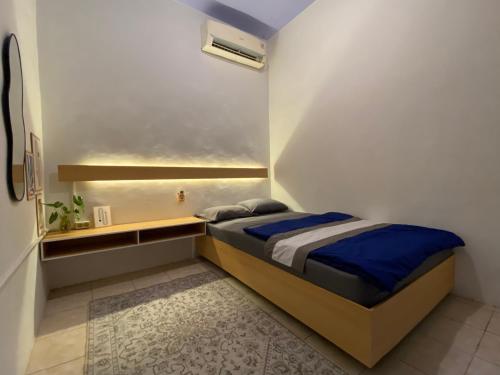 une petite chambre avec un lit dans une pièce dans l'établissement La Via Living, à Sukobumi