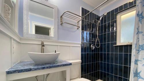 a bathroom with a sink and a mirror at Cuddlefish in Jekyll Island