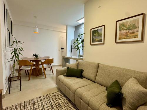 a living room with a couch and a table at 2-bedroom apartment, Home Office and panoramic view in São Carlos