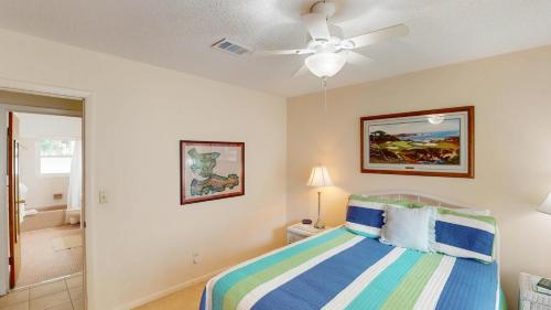 a bedroom with a bed and a ceiling fan at Reflection in Jekyll Island