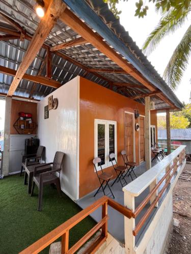 a small house with an orange and white exterior at Modo home in Komodo