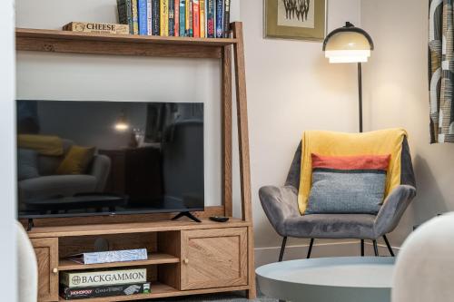 a living room with a chair and a large mirror at Sea Croft in Worthing