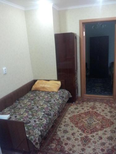 a small bedroom with a bed and a mirror at Квартира on Vlasova 23 in Pyatigorsk