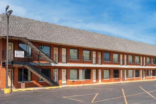 a red brick building with a staircase in a parking lot at Hotel O Miami Inn & Suites Chicago Midway Airport in Chicago