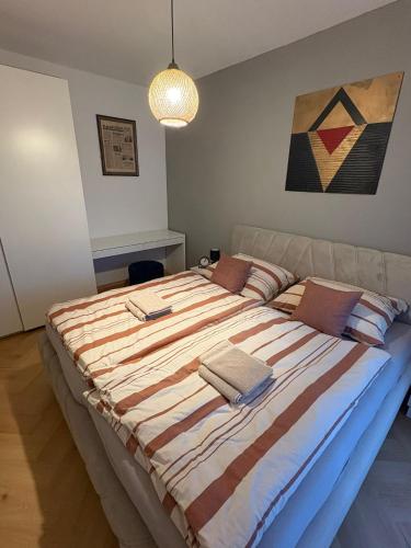 a bedroom with a large bed with towels on it at Kamence apartment with free parking in Kysucké Nové Mesto