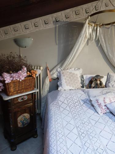 a bedroom with a canopy bed and a table with a basket at Creativ hause in San Giuliano Terme