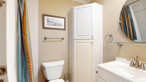 a bathroom with a white toilet and a sink at Villa 326 - A SHORE THING in Jekyll Island