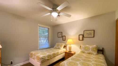 a bedroom with a bed and a ceiling fan at Very Nice Cottage in Jekyll Island