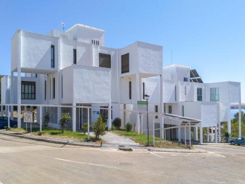 a white building on the side of a street at Apartamentos Embalse de Orellana in Orellana la Vieja