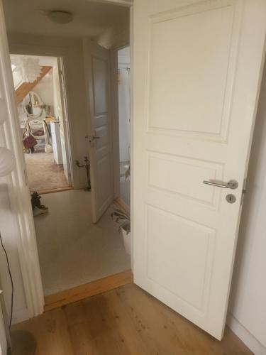 a hallway with a white door in a room at Nice Apartment in Aalborg
