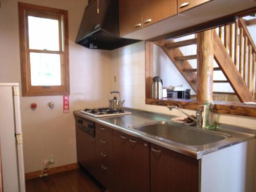 a kitchen with a sink and a counter top at Cottage All Resort Service / Vacation STAY 8419 in Inawashiro