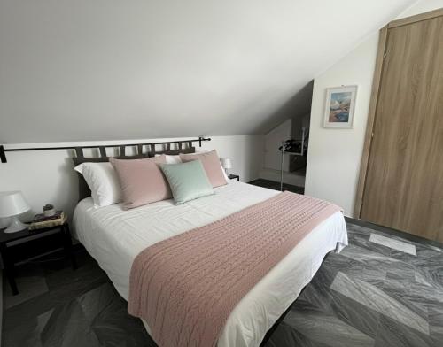 um quarto com uma cama grande e almofadas cor-de-rosa e verde em Tommy's Home-Allianz Stadium, Parco Dora em Turim