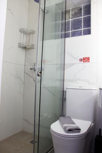 a bathroom with a toilet and a glass shower at Aenaon Corfu Luxury Apartments #03 - Aris Apartment in Ipsos