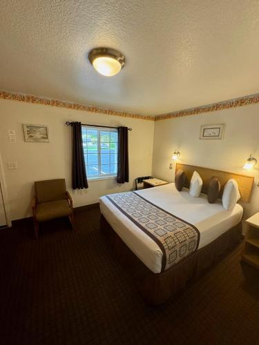 a hotel room with a large bed and a window at Ocean Breeze Motel in Florence