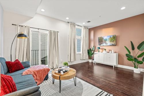 a living room with a blue couch and a table at Luxury 3BR Rooftop Apartment Walk to MET and Metro in Philadelphia