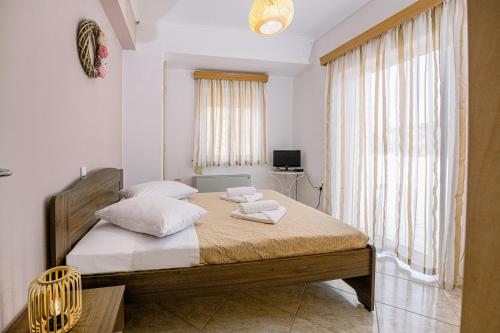 a bedroom with a bed with two pillows on it at Creta Sea View 2BR Maisonette by ΜΡS in Marathokefála