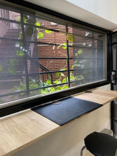 a window with a meditation mat in front of it at Hostel Nueva cordoba Subte Uno in Córdoba