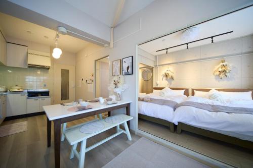 a bedroom with a large bed and a desk in it at Maison Etoile 706 / Vacation STAY 7561 in Nagoya