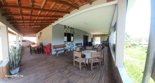 a porch of a house with a table and chairs at Chácara maravilha in Monte Sião
