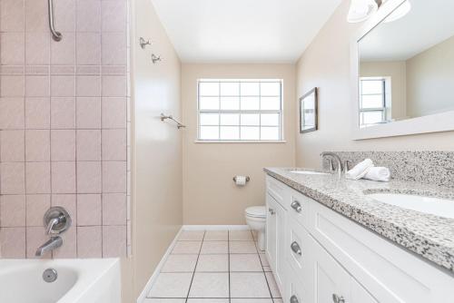 a bathroom with a shower and a sink and a toilet at Pet-Friendly 3Br W Ac & Rooftop Deck 2 Houses From Beach By Beachview Rentals in Newport Beach