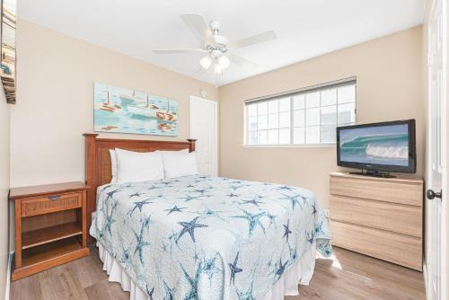 a bedroom with a bed and a flat screen tv at Pet-Friendly 3Br W Ac & Rooftop Deck 2 Houses From Beach By Beachview Rentals in Newport Beach