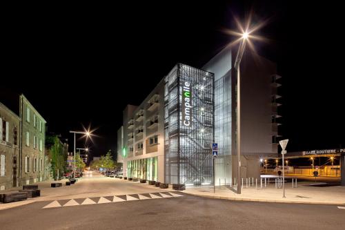 a building on a city street at night at Campanile La Roche Sur Yon Centre Gare in La Roche-sur-Yon