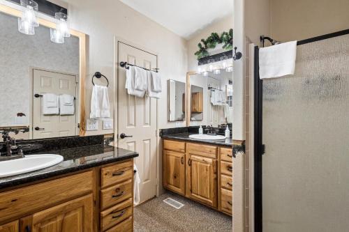 a bathroom with two sinks and a shower at The Shady Grove Retreat in South Fork