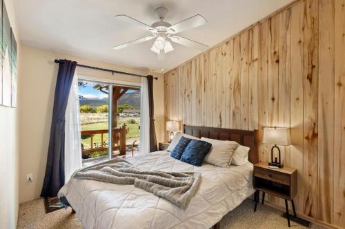 a bedroom with a bed with a wooden wall at The Shady Grove Retreat in South Fork