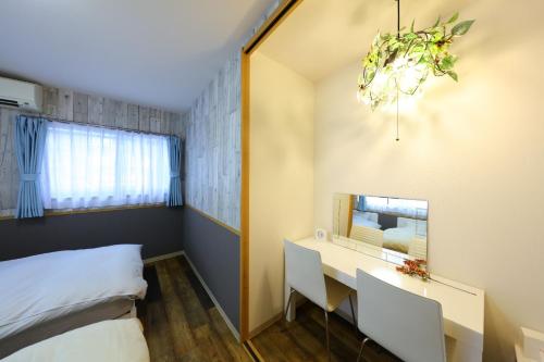 a bedroom with a bed and a desk and a window at Dai6 Prosper Building, 2nd floor - Vacation STAY 74808v in Nagoya