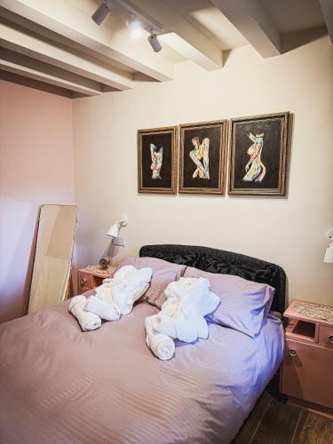 a bedroom with a bed with towels on it at Maus Haus in Vrdnik