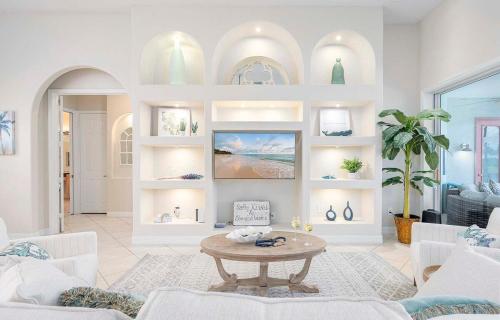 ein Wohnzimmer mit Tisch und Couch in der Unterkunft Palm Pointe - Waterfront Vacation Rental Cape Cora in Matlacha