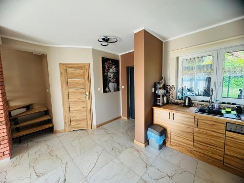 a kitchen with a sink and a counter top at Zajazd Jędruś - Domki Całoroczne in Idzików